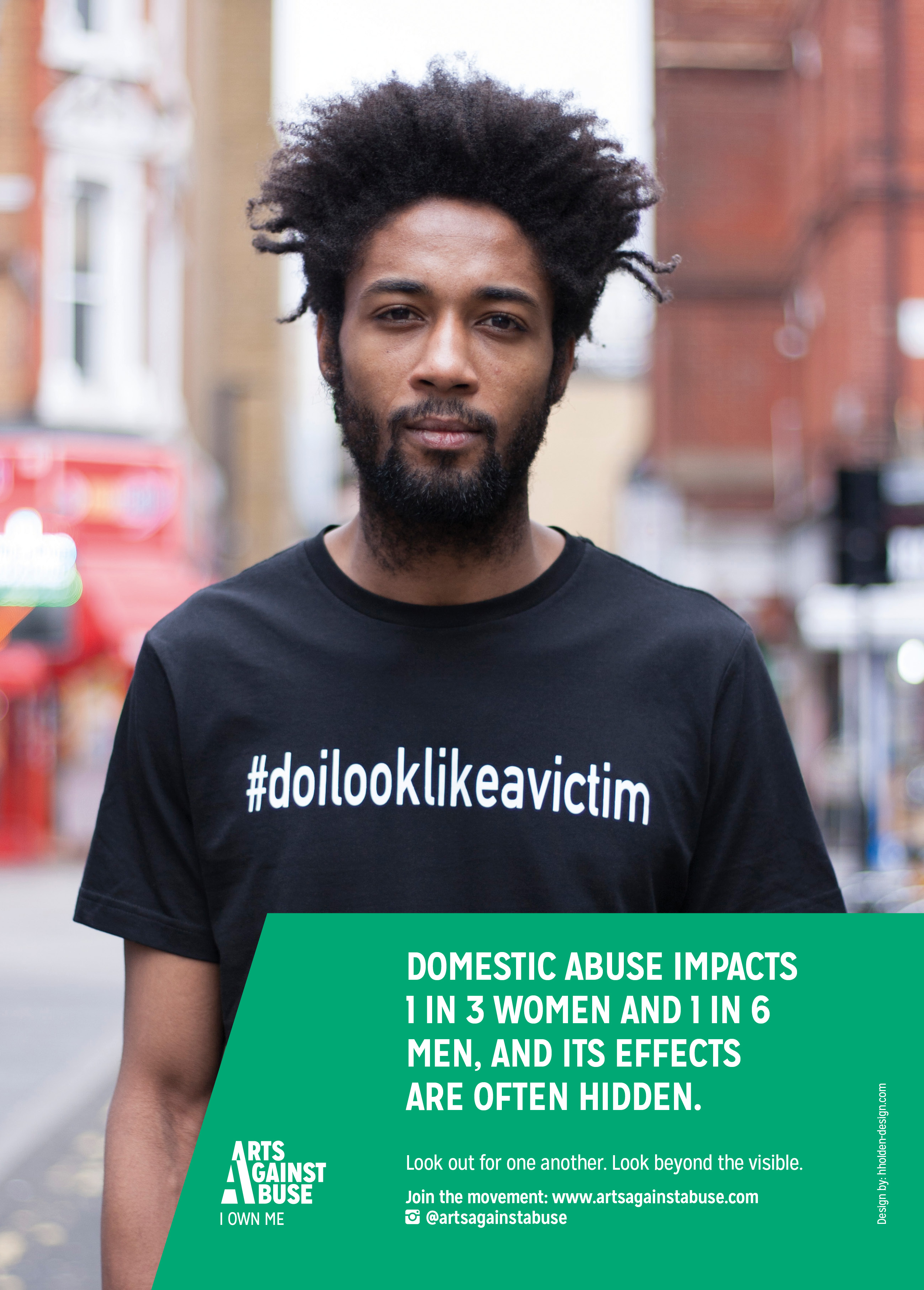A photograph shows a man wearing a t shirt with the hashtag do i look like a victim and a text box that reads 'domestic abuse impacts one in 1 in 3 women and 1 in 6 men' alongside the Arts Against Abuse logo.